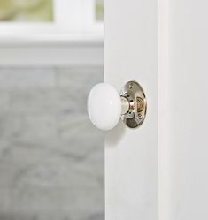 a white door handle with a glass ball on it