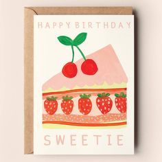 a card with a piece of cake and strawberries on it