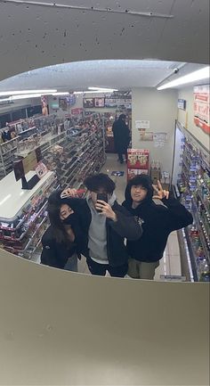 three people taking a selfie in a store