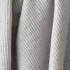 closeup of the textured fabric on a grey shirting material that has been folded over