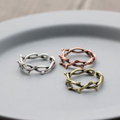 three different colored rings on a plate with one ring in the middle and one is made out of metal