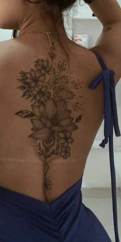 the back of a woman's body with flowers on it