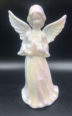 a white angel figurine sitting on top of a table