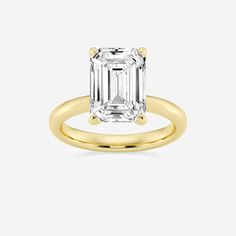 an emerald - cut diamond ring in yellow gold