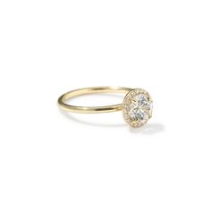 a yellow gold ring with a diamond center