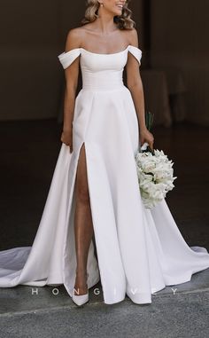 a woman in a white dress holding a bouquet