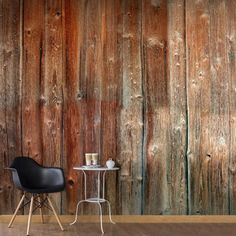 a chair and table in front of a wooden wall