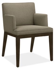 the arm chair is upholstered with a dark wood frame