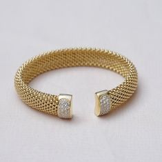 Tubogas Bracelet in 18k gold vermeil 925 sterling silver with cubic zirconia diamonds * Material: Gold Vermeil (18 k 1 micron gold on sterling silver) ∙ High Quality Solid 925 Sterling Silver ∙ 18K Gold * Weight: 23 g * Finish: 18K Gold ∙ 925 Sterling Silver * Dimensions: 12 mm width OTHER INFORMATION * Sold in 1 piece * Made in Italy * Tarnish-free * Nickel and Lead-free * Hypoallergenic / Made for Sensitive Skin * All items are nicely packaged ready to gift in jewelry pouches. * Need more info Gold Cuff Bracelet With Jubilee Style In Cubic Zirconia, Gold Bangle With Pave Setting As Gift, Gold Cubic Zirconia Cuff Bracelet For Formal Occasions, Gold Cubic Zirconia Cuff Bracelet With Jubilee Style, Gold Pave Setting Cuff Bracelet For Formal Occasions, Gold Cubic Zirconia Cuff Bracelet With Jubilee Design, Adjustable Yellow Gold Bangle In Cubic Zirconia, Formal Gold Cuff Bracelet With Pave Setting, Gold Cubic Zirconia Jubilee Cuff Bracelet