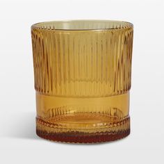 a yellow glass cup sitting on top of a table