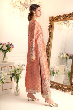 Elevate your style quotient this wedding season, with this romantic multi- paneled A-line shirt, beautifully adorned with botanical embroidery with dabka, pearls, kundan, glistening sequins, delicate beads and resham work. This relaxed fit shirt is paired with gota detailed izaar and two tone katan silk jacquard dupatta adorned with gota and sequin embellishments to complete the festive look of this outfit Shirt Fabric: Pure jacquard Soft tissueShirt Length: 48” (customisable, mention in order n Reception Sherwani With Zari Work In Georgette, Unstitched Party Wear Kurta For Reception, Party Wear Kurta With Resham Embroidery For Receptions, Party Wear Resham Embroidery Kurta For Reception, Semi-stitched Georgette Sherwani For Reception, Festive Semi-stitched Georgette Sherwani, Dola Silk Kurta With Mirror Work For Reception, Reception Chinon Kurta With Dabka Work, Reception Sherwani With Dupatta In Georgette