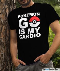 a man standing next to a tree wearing a pokemon go is my cardio t - shirt