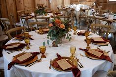 the table is set with gold and red place settings