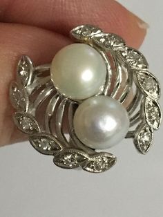 Details: A Unique and one of a kind Ring Handmade Vintage Ring Custom Made Ring (Estimated Late 1960's Early 1970's) 14Karat White Gold Ring Shank is nice and wide 2 Cultured Pearls in the Center One Pearl color is White the other has a silver tone color There are 12 diamond Stones around the Crown Estimate Total Weight .25ct Ring weight : 7.3 Grams Ring is appraised for the value of $2750 Since the following ring is Vintage no changes will be made to the ring Ring will be shipped via FEDEX seco Pearl Rings Vintage Sales, Antique Hallmarked Pearl Ring For Wedding, Vintage Pearl And **** Ring, Luxury Vintage Pearl Ring, Vintage Multi-stone Pearl Ring For Formal Occasions, Pearl Rings Vintage, Pearl And Diamond Ring, Vintage Diamond Rings, Vintage Pearls