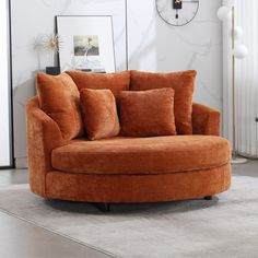 a living room with a round couch and clock on the wall