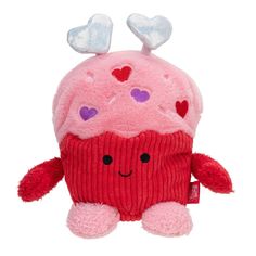 a pink cupcake stuffed animal with hearts on it's head and two eyes