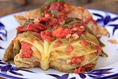 a plate topped with lasagna covered in sauce