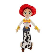 a toy doll with red hair and white shirt on it's head, wearing cowboy pants