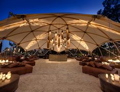 the inside of a tent is lit up with candles