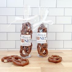 two bags of pretzels sitting next to each other on a wooden counter top