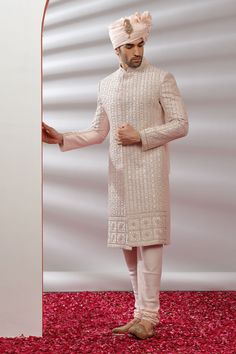 Top Details Color- Peach, Fabric - Soft Blended Silk With Embroidered Bottom Details Color- Peach, Fabric - Dhupion Silk, Style - free size churidar Package Include :INCLUDES 1 SHERWANI,1 CHUDIDAR AND NO STOLE Turban ,Mojari And Other Accessories Are Not Sold Along With The Dress. CARE: DRY CLEAN ONLY Additional Information : - As This Sherwani/Waistcoat/Kurta Are Made As Per Orders So It Is Strictly Not Acceptable Once Get Delivered .So Kindly Choose Body Fit Size . Also We Keep 2 Inches Extra Traditional Pink Bandhgala For Wedding, Wedding Pink Bandhgala With Intricate Embroidery, Traditional Unstitched Suit For Reception, Traditional Nehru Jacket For Wedding And Eid, Bollywood Nehru Jacket With Chikankari Embroidery For Wedding, Pink Traditional Bandhgala For Wedding, Wedding Nehru Jacket With Chikankari Embroidery For Eid, Traditional Sherwani With Pallu For Reception, Nehru Jacket With Chikankari Embroidery For Wedding And Eid