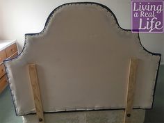 an upholstered headboard is being made into a bed