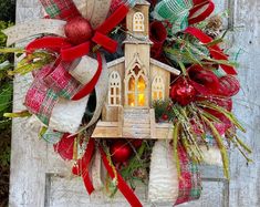 a christmas wreath hanging on the side of a wooden door with bells and ornaments around it