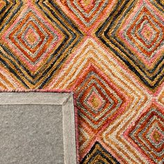 an area rug with different colored squares on it and a small square in the middle