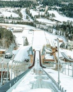 an aerial view of a snow covered ski slope and the surrounding area is shown in winter