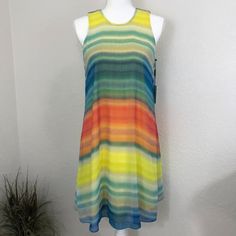 Calvin Klein Dress. Sleeveless A-Line Multi Colored Dress. Has A Thread Run On The Front Of The Dress. Brand: Calvin Klein Size: 4 Color: Yellow/Blue Multi Color Approximate Measurements: Length 36in (Shoulder To Hem) Bust 19in (Flat Across) Waist 18.5in (Flat Across) Material: Polyester Multicolor Midi Sleeveless Beach Dress, Colorful Sleeveless Sundress For Spring, Colorful Sleeveless Spring Sundress, Vibrant Sleeveless Summer Mini Dress, Vibrant Sleeveless Mini Dress For Summer, Flowy Multicolor Sleeveless Dress For Spring, Colorful Sleeveless Mini Dress For Summer, Multicolor Sleeveless Lined Dresses, Colorful Sleeveless Summer Mini Dress