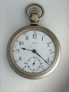 "Regina Omega J.W Dayman Antique Railroad Pocket Watch Porcelain Dial swiss Made Regina pocket watches were a brand of pocket watches made by Omega that were popular in the early 1900s. The name Regina Pocket Watch was originally trademarked by LOUIS MAIER in Bienne Switzerland in 1888. The name was then trademarked by Omega in 1911, indicating that they bought the company at that time. The faces and mechanisms were imported into New York and assembled with cases in Ontario, for sale mostly in C Vintage White Chronograph Watch Accessories, Vintage White Round Watches, Classic Round Stopwatch Watch, Classic Round Watch With Stopwatch, Old Records, Pocket Watch Antique, Pocket Watches, Beautiful Watches, Early 1900s