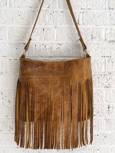 This gorgeous distressed fringe hobo is an absolute classic. It measures 14 inches wide, 11 inches in height and has a depth of 4 inches. There is an interior pocket for your smaller items and a strong magnetic clasp for closure. Handmade from my studio in Greenville, South Carolina. Chic Bucket Shoulder Bag With Tassels, Chic Rectangular Hobo Bag With Fringe, Chic Rectangular Fringe Hobo Bag, Brown Bucket Bag With Tassels For Everyday, Chic Tote Shoulder Bag With Tassels, Chic Brown Hobo Bag With Tassels, Chic Tassel Tote Shoulder Bag, Fall Fringe Satchel Bag, Daily Use Tassel Tote Satchel