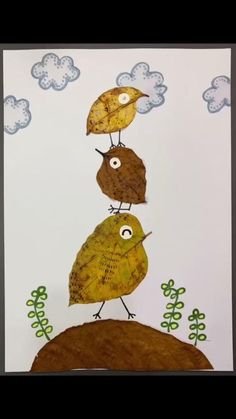 two birds standing on top of each other with clouds in the sky above them and trees below