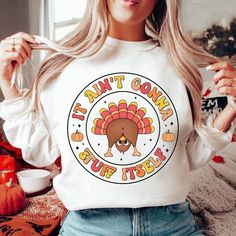 a woman wearing a white shirt with a turkey on it's chest and the words, i can't go wrong but try thanksgiving