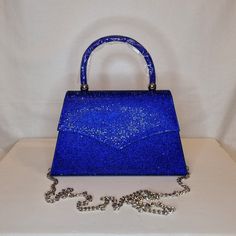 Womens royal cobalt blue crystal encrusted luxury evening clutch bag with silver embellishment, metallic satin finish material and magnet front closing top  Can be used with or without long shoulder chain (included) size approx- H 13cm x W 22cm Free Royal Mail delivery is an estimated 3-5 days but this can occasionally be slightly longer which solely on the Royal Mail side. We do offer guaranteed next day delivery but please contact us prior to ordering as this would incur a small upgraded shipping charge. We also offer WORLDWIDE shipping - please contact us for more info 💕🌍 Blue Evening Bag With Rhinestones, Blue Rhinestone Clutch Evening Bag, Blue Rhinestone Clutch For Party, Blue Rhinestone Clutch For Events, Glamorous Blue Bags With Rhinestones, Blue Evening Clutch With Rhinestones, Blue Rhinestone Clutch For Evening, Royal Blue Rectangular Evening Bag, Glamorous Blue Formal Bag