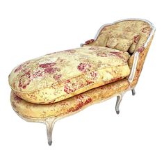 an antique chaise lounge chair with floral upholster