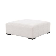 a white ottoman sitting on top of a wooden table