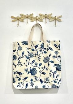 "This is hand made reusable shopping bag by Cape Crafter Inc. It's made of printed designer's fabric and cotton webbing handles. There are no pockets on the bag, but if you want one please convo me and I will added for you. The handles are made of 100% natural cotton webbing.  The bag is perfect for: - grocery bag - purse - beach bag  - family bag - picnic bag  - mother's day gift - bridesmaid gift - diapers bag - shopping bag and many more DIMENSIONS: 16\" Wide when flat 18\" High Bottom is 4\" Rectangular Cotton Canvas Bag For Market, Reversible Cotton Canvas Bag For Daily Use, Cotton Tote Canvas Bag For Market, Cotton Canvas Tote Bag For Market, Handmade Cotton Bag For Market, Handmade Cotton Bags For Market, Eco-friendly Cotton Canvas Market Bag, Cotton Hand Printed Bags For Everyday Use, Handmade Cotton Canvas Bag For Everyday Use