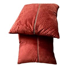 two red pillows sitting on top of each other