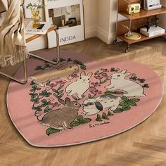 a pink rug with rabbits on it in a room next to a chair and bookshelf