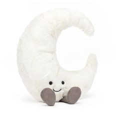 a white stuffed animal sitting in the shape of a letter c on a white background