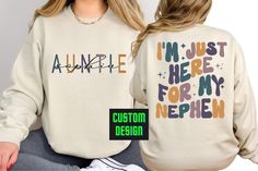 Elevate Auntie Style with Our Custom I'm Just Here Auntie Sweatshirt A Thoughtful Gift for Aunts Everywhere. The witty and charming statement, 'I'm Just Here,' not only adds a playful element but also captures the essence of the cool and laid-back auntie vibe. It's the perfect shirt for any occasion - whether you're spending quality time with your nephew, attending family gatherings, or simply embracing your role as the fun and stylish aunt. Surprise your favorite aunt with this thoughtful and p Fall Birthday Crew Neck Tops, Graphic Print Tops For Birthday In Fall, Fall Birthday Tops With Name Print, Casual Tops For Fall Birthday, Auntie Sweatshirt, Aunts Birthday, Aunt Birthday Gift, Aunt Shirt, Auntie Shirts