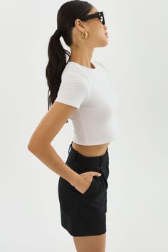 Elevate your basics with the INGA cropped t-shirt. The shortened length is perfect for a laid-back vacation atmosphere. It effortlessly pairs with various bottoms, from shorts and skirts to jeans or casual trousers, allowing you to create different looks with minimal effort. Sporty Cropped T-shirt With Short Sleeves For Summer, Sporty Crop Top For Everyday Summer Wear, White Cropped T-shirt For Summer In Athleisure Style, Casual Cropped Hem Bottoms For Summer, Summer Athleisure Short Sleeve Crop Top, Sporty Cropped T-shirt For Everyday, Summer Cropped T-shirt With Relaxed Fit, Relaxed Fit Short Sleeve Athleisure Crop Top, Relaxed Fit Short Sleeve Crop Top In Athleisure Style