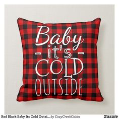 a red and black plaid pillow with the words baby it's cold outside on it