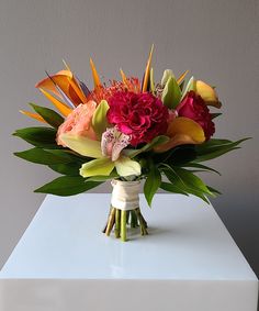 a bouquet of flowers sitting on top of a white table