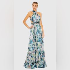 Mac Duggal Floral Haulter A Line Gown W Cutouts & Embellished Belt Dress Nwt Size 8 Style: 68089 Floral Print Evening Dress For Spring Gala, Glamorous Floor-length Floral Print Dress, Spring Gala Long Gown, Blue Floral Print Gown For Spring, Blue Floral Print Dress For Gala, Blue Floral Print Gala Dress, Glamorous Spring Long Dress Gown, Spring Gala Gown With Floral Print, Glamorous Spring Long Gown