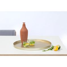 a table with a vase and two glasses on it