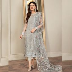 Fabric: Finest Quality Net Same As Picture: Yes 100% Step into the spotlight with the show-stopping Hand Embellished Light Gray Shalwar Kameez! This masterpiece from PK Bridals is not just a dress; it's an experience that promises to transform your special occasions into unforgettable moments. Elegance Elevated Picture this: an extravagant pastel canvas adorned with silver sequins and intricate embroideries that shimmer with every step you take. The Jade Grey Salwar Suit is designed for those wh Net Shirt, Pakistani Wedding Dress, Pakistani Fancy Dresses, Luxury Wear, Embroidered Neckline, Pakistani Dress Design, Pakistani Designers, Shalwar Kameez, Trouser Style