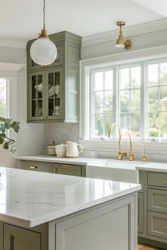 a kitchen with green cabinets and white counter tops