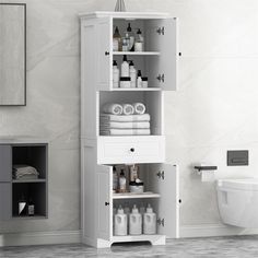 a white bathroom cabinet with lots of bottles and towels on the shelf next to it